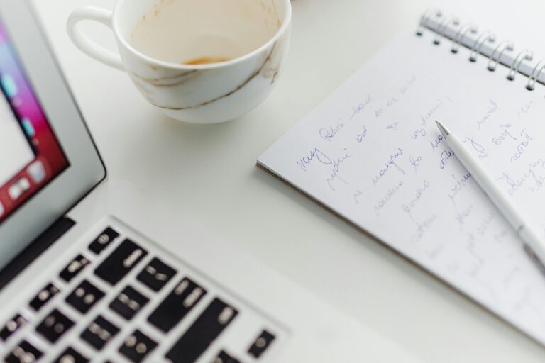 Laptop notebook and coffee on desk for writing