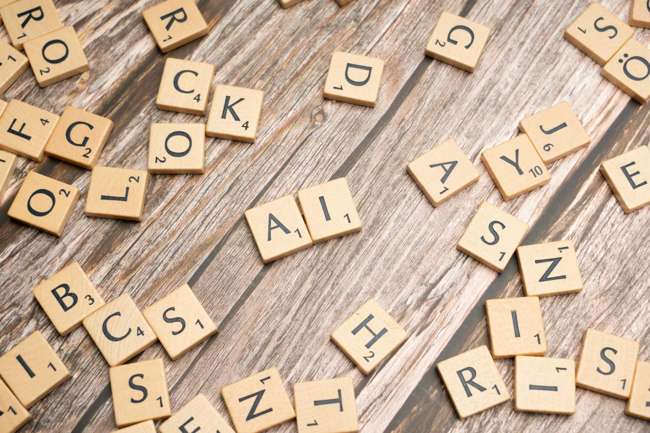 Scrabble tiles spelling AI on wooden surface