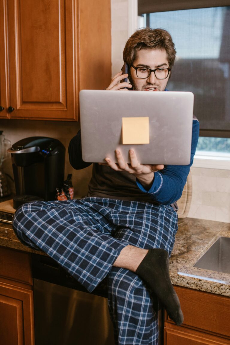 Happy man working on laptop earning money online with AI